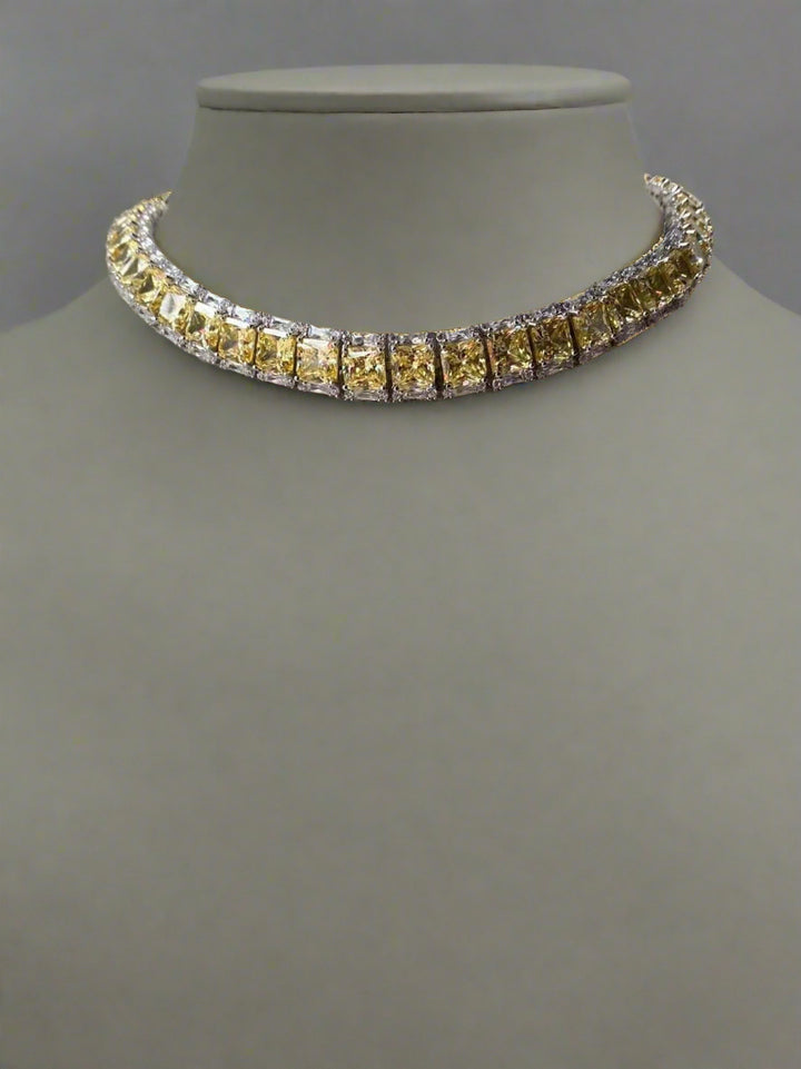 Necklace with yellow gemstones on a gray mannequin bust