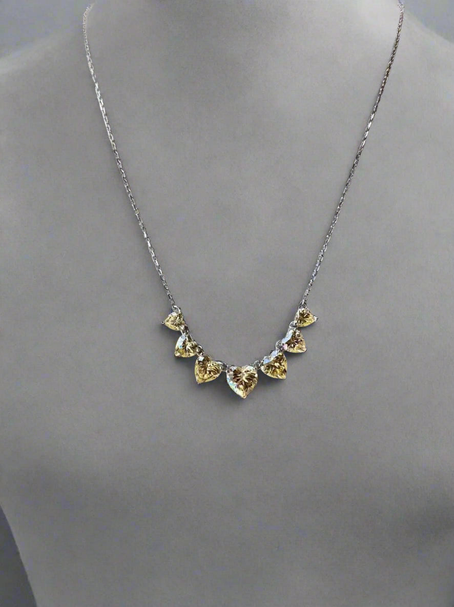 Necklace with heart-shaped stones on a gray mannequin