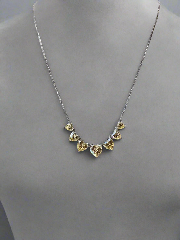 Necklace with heart-shaped stones on a gray mannequin