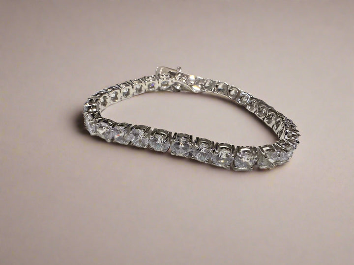Luxe Crystal Tennis Bracelet on beige background.