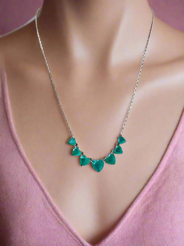 Necklace  pendant on a mannequin wearing a pink  sweater.